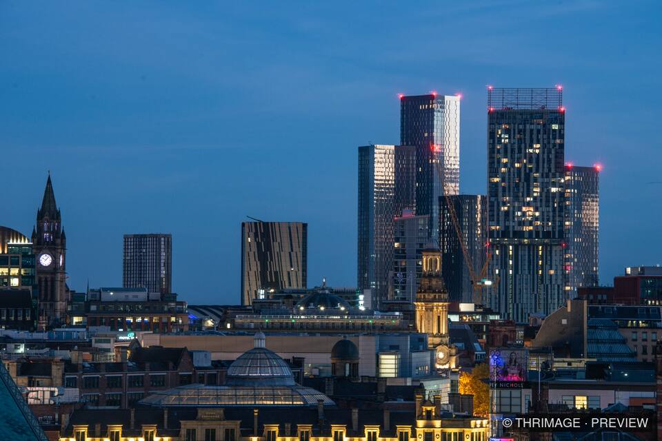 Manchester city skyline illuminated during blue hour
