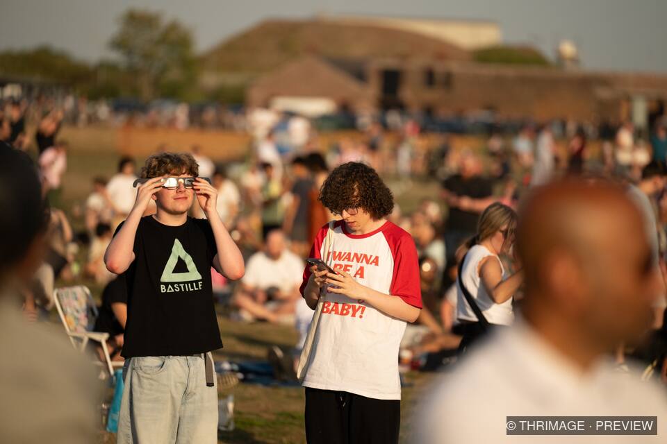 Visitors observing the sky at an outdoor astronomy event