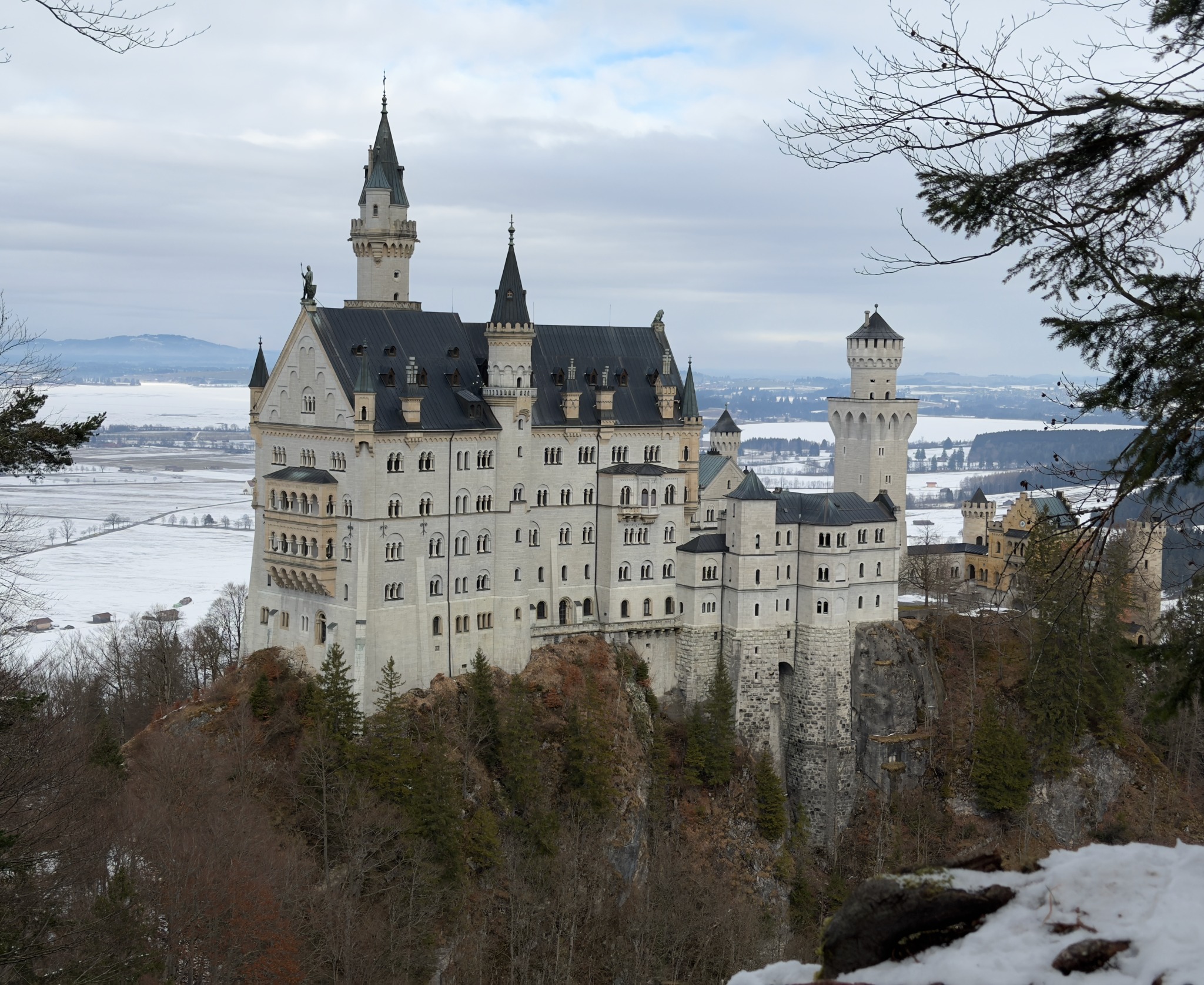 Neuschwanstein Castle rising above a snow-covered Bavarian landscape in winter